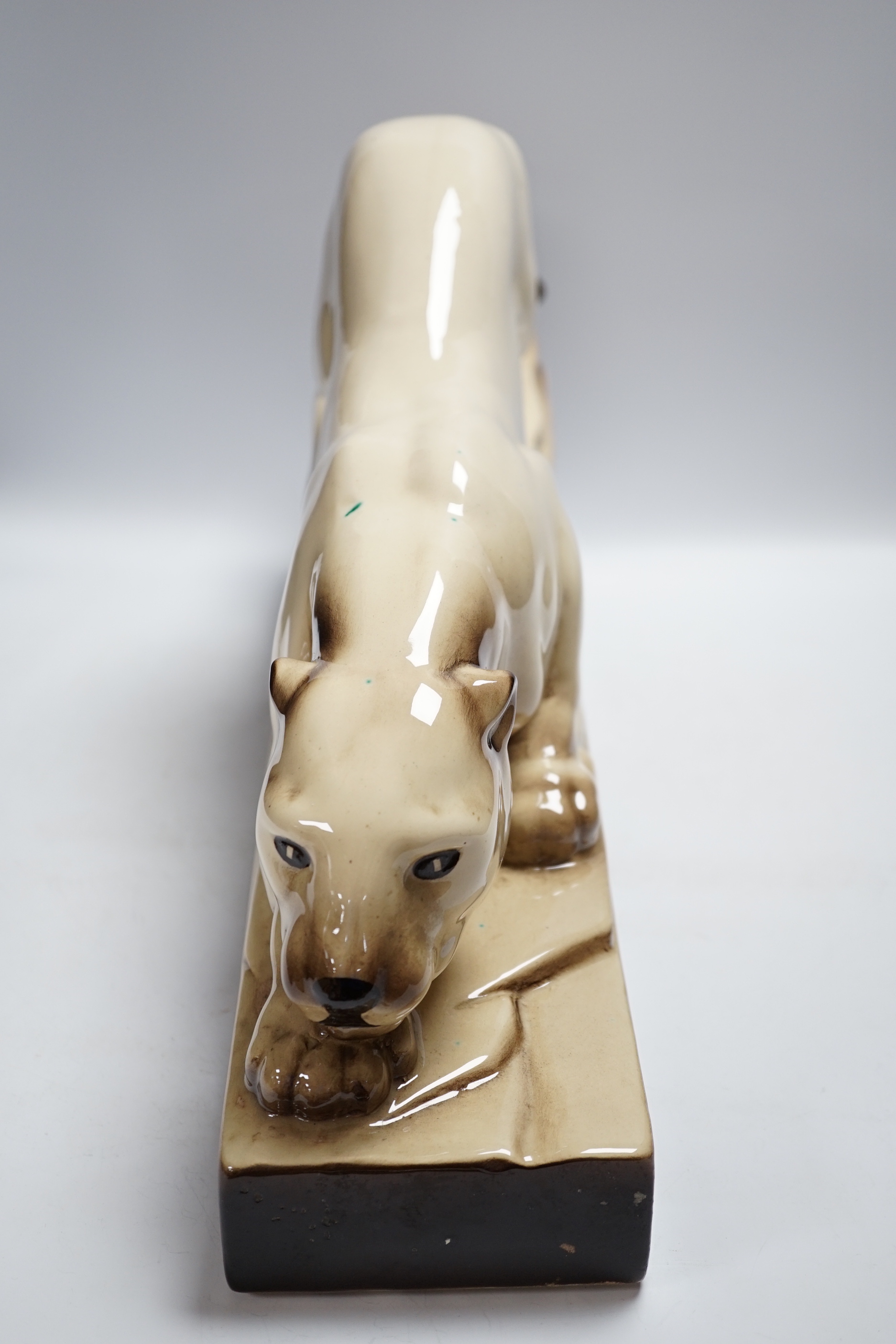 An Art Deco porcelain model of a panther, indistinctly signed, 57cm